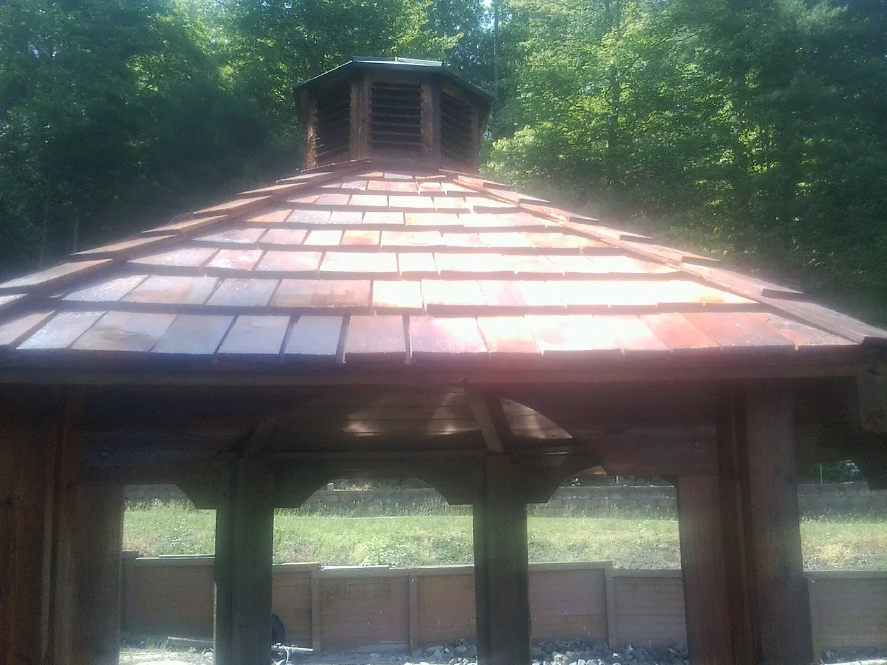 New cedar shake roof and cupola on a lakeside gazebo in Liberty
